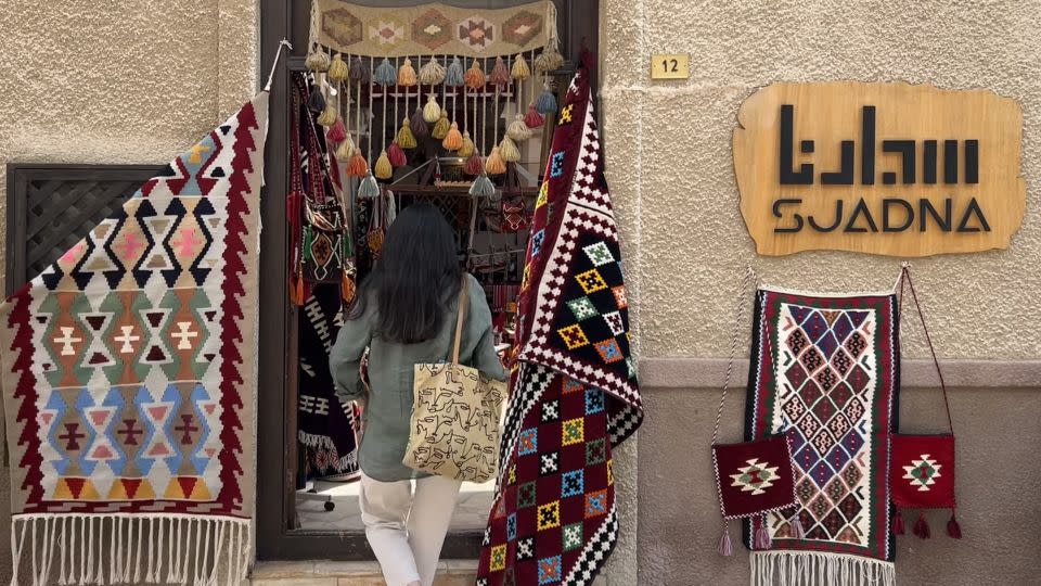 In Al Fahidi Historical Neighborhood, Badran stops at Suadna, a textile store weaving traditional rugs, bags and decorative hangings. - Rebecca Cairns/CNN