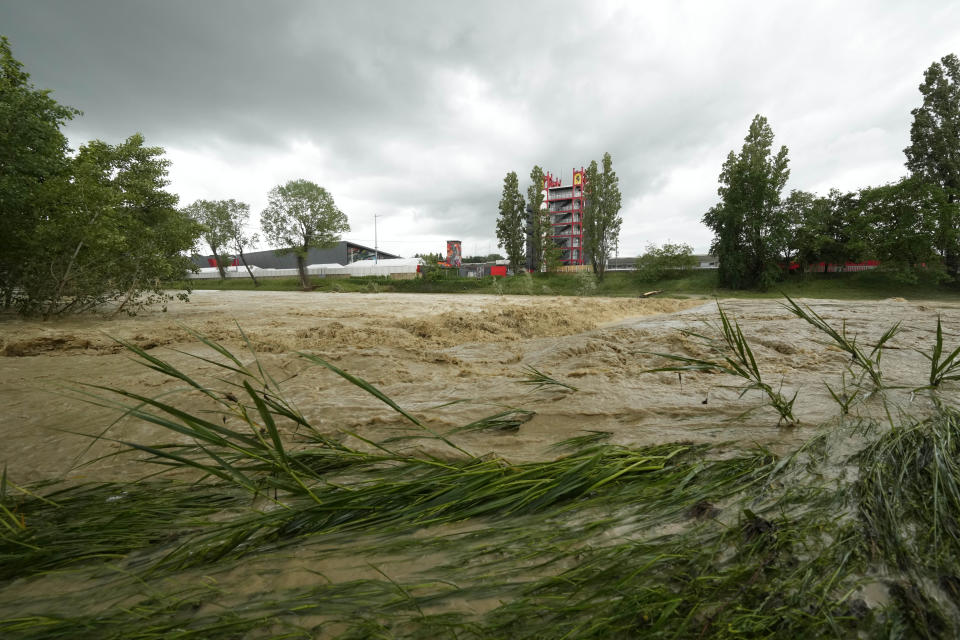 A view of the swollen Santerno River with behind the Enzo e Dino Ferrari circuit, in Imola, Italy, Wednesday, May 17, 2023. The weekend's Emilia-Romagna Grand Prix in Imola has been canceled because of deadly floods. Formula One said it made the decision for safety reasons and to avoid any extra burden on the emergency services. F1 personnel had earlier been told to stay away from the track after floods affected large parts of the Emilia-Romagna region. (AP Photo/Luca Bruno)