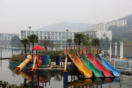 An unused and rusting playground outside a hotel on the shores of Lake Tai, is pictured in Yixing city, where the local government is working to develop the local tourism industry, Zhejiang province, China November 14, 2017. REUTERS/Christian Shepherd