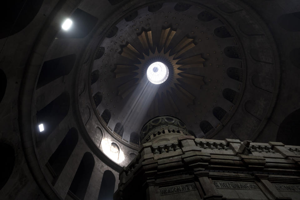 Morning sun filters into the Holy Sepulcher, the site where according to tradition Jesus was crucified and buried, in the Old City of Jerusalem, Thursday, April 6, 2023 during the Holy Thursday Mass. (AP Photo/Maya Alleruzzo)