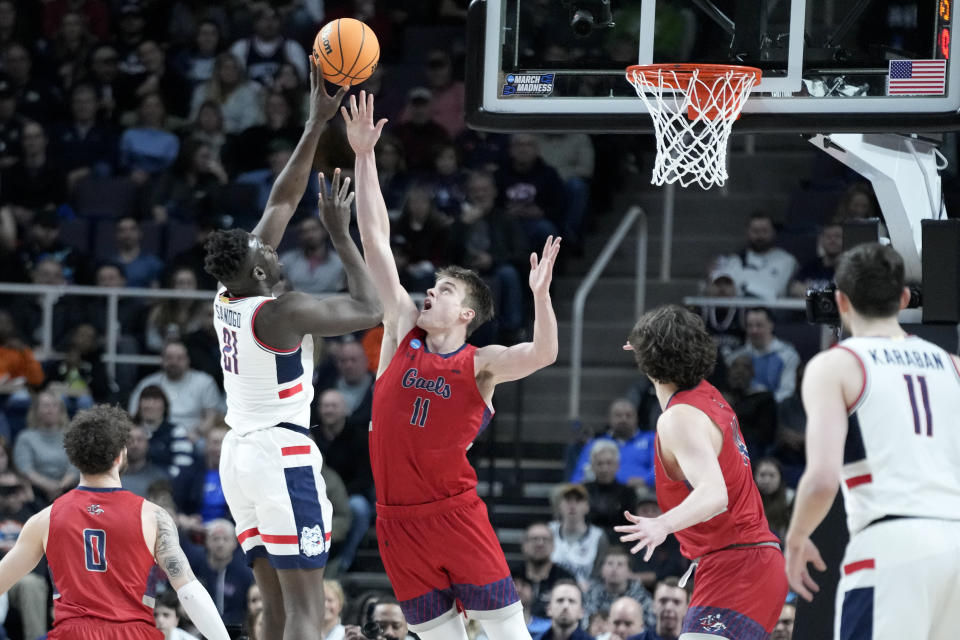 Connecticut's Adama Sanogo (21) shoots against St. Mary's Mitchell Saxen (11) in the first half of a second-round college basketball game in the NCAA Tournament, Sunday, March 19, 2023, in Albany, N.Y. (AP Photo/John Minchillo)