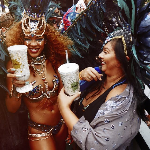 Rihanna was once again back in Barbados for the annual Crop Over festivities, and this time, she had a famous friend in her squad. The 27-year-old singer was spotted partying and dancing with Nicole Scherzinger's ex-fiance, Lewis Hamilton, at the Crop Over's Kadooment Day Parade. The 30-year-old shirtless British race car driver celebrated wearing a backwards hat, trendy sunglasses and a colorful bandanna around his neck. Both his Calvin Klein underwear and his rock-hard abs were in full view. Splash News The hat was apparently covering up his new 'do. "Barbados, we ready!! #Islandlife #Carnival2015," Hamilton captioned a selfie of his hair. While recent pics of Rihanna and Hamilton partying are sparking romance rumors, the two known each other for a few years. In Dec. 2014, the two posed together at the British Fashion Awards in London, and in 2011, they were also photographed at the Canadian Grand Prix. <strong> WATCH: Rihanna Taped Floyd Mayweather's Mouth Shut at BET Awards </strong> While Hamilton was a nice addition to the party, all eyes were on Rihanna and her show-stopping costume on Monday. Like those Crop Over styles from years past, the intricately beaded getup included a barely-there bra and booty-baring bikini bottoms. Rihanna paired her sexy style with a huge headdress and giant wings. The outlandish pop star knew she looked good because she couldn't stop Instagramming during the festivities on Monday. She even posted a video of her booty shaking that's nearly NSFW. <strong> PHOTOS: Nearly Naked Rihanna Takes Over Kadooment Day Parade With Best Costume Yet </strong> One thing's for sure, RiRi knows how to party and so does her best gal pal Jennifer Rosales, who was also in attendance. <strong> PHOTOS: Rihanna Might Just Be the Best Bridesmaid Ever </strong> Hamilton is one lucky guy to be partying with these gals! Squad goals, indeed. 