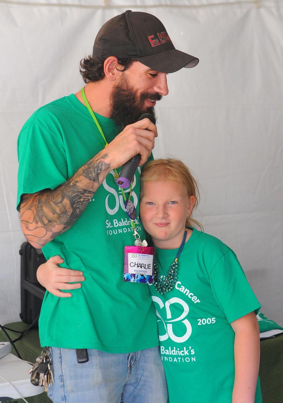 Charlie Miller receives support from his daughter, Carmen, a cancer survivor, during the 7th annual Alliance St. Baldrick's event that benefits the foundation that fights to help children battling cancer. Miller raised more than $1,100 in donations for the Sept. 18, 2022, event, which raises money for cancer research.