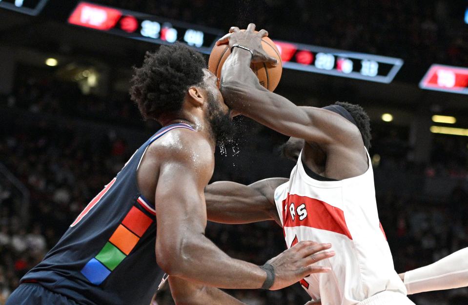 Toronto Raptors forward Pascal Siakam, right, elbows Philadelphia 76ers center Joel Embiid in the face as he drives to the basket in the final minutes of Game 6 of their first-round series at Scotiabank Arena.