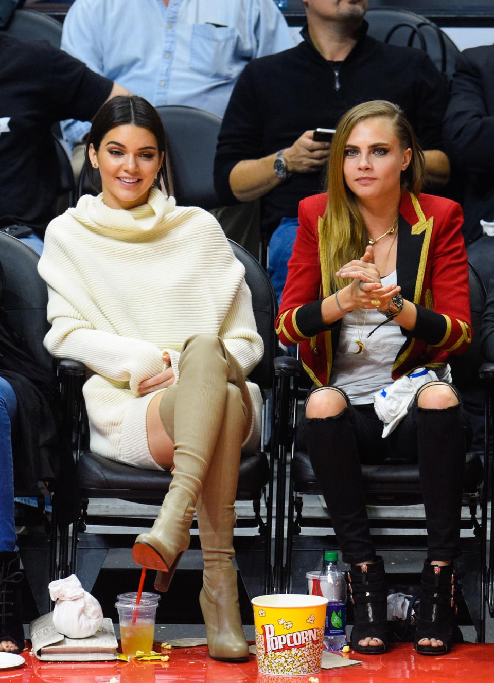 Models always have to dress the part, right? Taking in a Clippers vs Lakers showdown, Kendall Jenner chose taupe over-the-knee Christian Louboutin boots and an oversized white sweater dress. Her partner in crime, Cara Delevingne, donned a bandleader-like coat with peep-toe heels. Bonus points go to the latter for wearing the colors of the home team. 