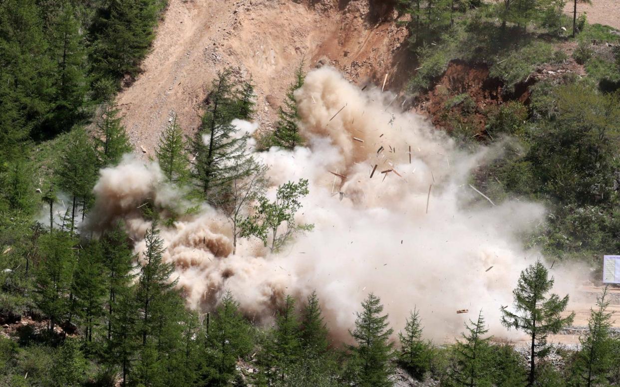 A tunnel of Punggye-ri nuclear test ground is blown up during the dismantlement process  - REUTERS