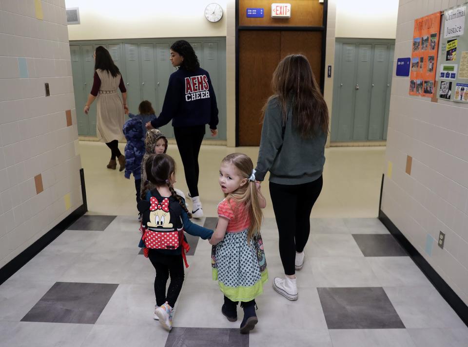 High school students walk preschoolers to their classroom during Appleton East's Little Patriots Preschool at Appleton East High School on Thursday, Feb. 16, 2023, in Appleton, Wis.