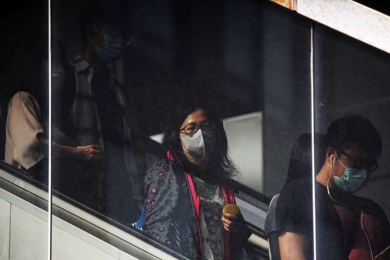 People go to work wearing protective face masks, amid coronavirus disease (COVID-19) concerns, in Taipei