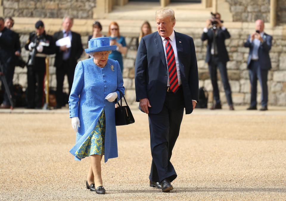 US President Donald Trump (R) and Britain's Queen Elizabeth II (L) leave the Quadrangle after inspecting a Guard of Honour during a ceremonial welcome at Windsor Castle in Windsor, west of London, on July 13, 2018 on the second day of Trump's UK visit. - US President Donald Trump on Friday played down his extraordinary attack on Britain's plans for Brexit, praising Prime Minister Theresa May and insisting bilateral relations 