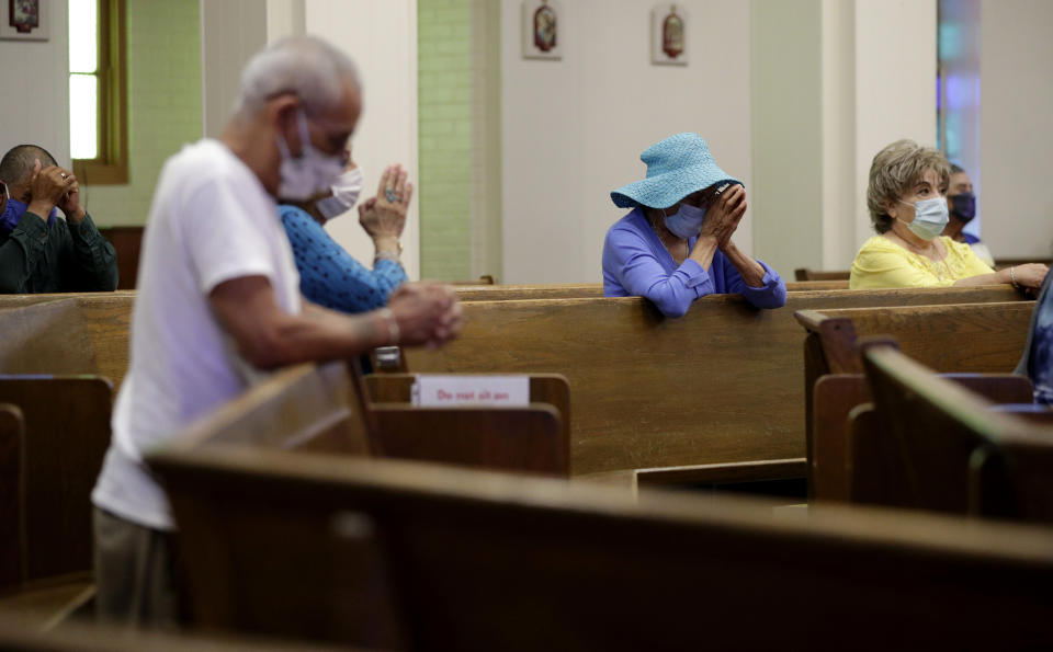 FILE - Parishioners wear face masks as they attend an in-person Mass at Christ the King Catholic Church in San Antonio, Tuesday, May 19, 2020. For the first time in nearly two decades, only half of U.S. households donated to a charity, according to a study released Tuesday, July 27, 2021. Experts say many factors are contributing to the decline. The percentage of Americans who give to religious causes has decreased in tandem with attendance at worship services as the number of Americans not affiliated with any religion grows. (AP Photo/Eric Gay, File)