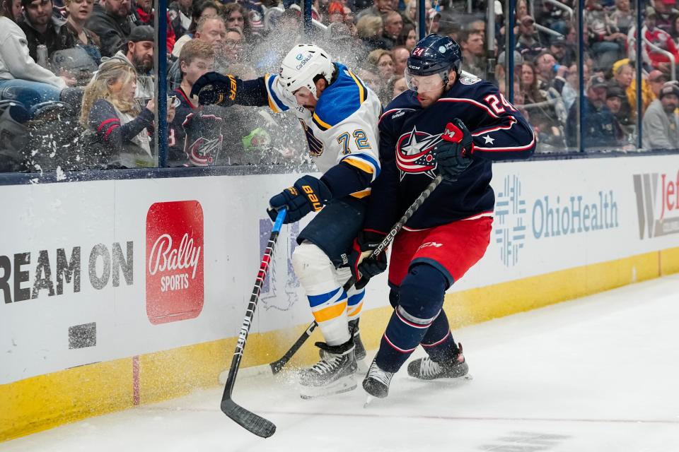 Dec 8, 2023; Columbus, Ohio, USA; Columbus Blue Jackets right wing Mathieu Olivier (24) hits St. Louis Blues defenseman Justin Faulk (72) during the third period of the NHL game at Nationwide Arena. The Blue Jackets won 5-2.