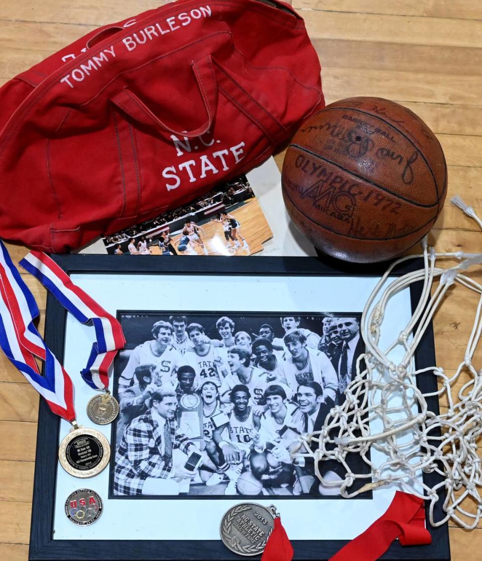 A selection of the memorabilia that former N.C. State center Tommy Burleson has saved from his basketball career, including his travel bag while with the Wolfpack and a signed basketball from the 1972 U.S. Olympics team.