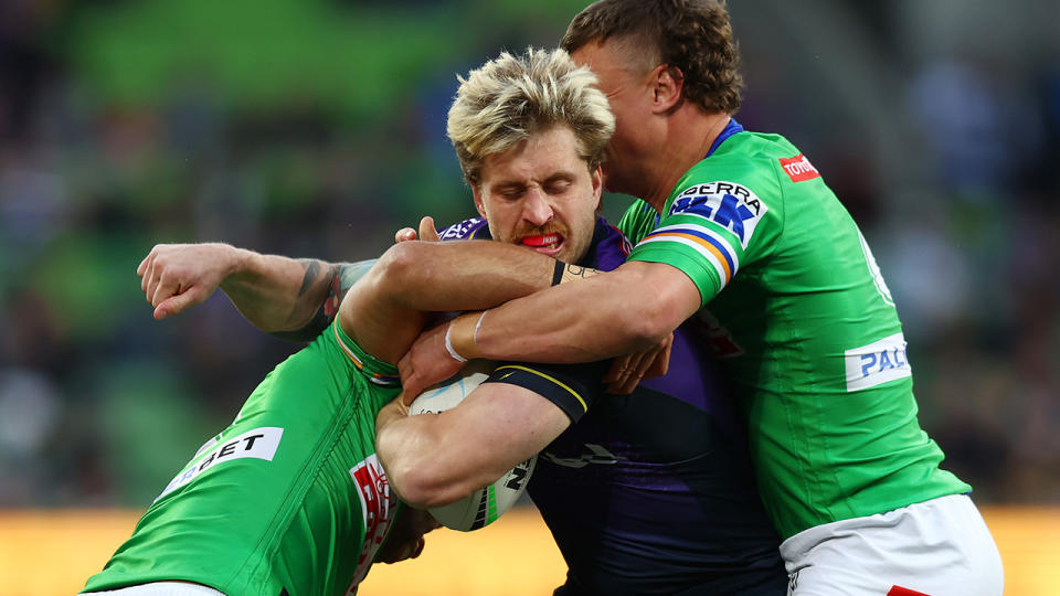 Cameron Munster is tackled during the Storm's NRL final against the Canberra Raiders.