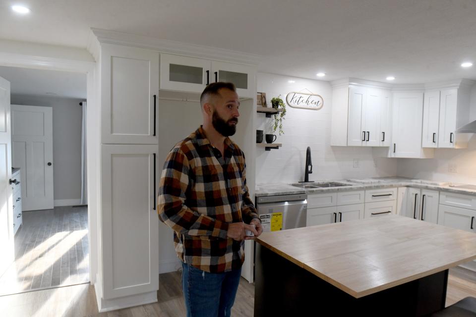 Realtor Kenny Mayle talks in the kitchen of a Lake Township home which has been remodeled in a modern farmhouse style.