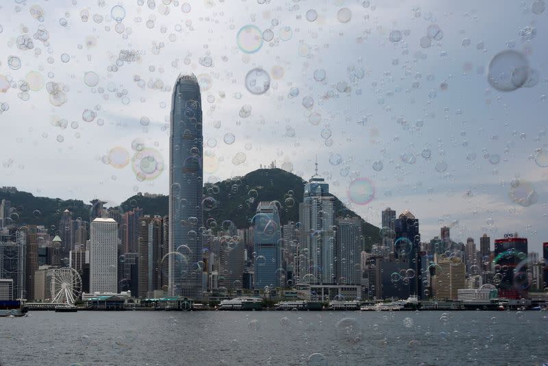 Bubbles are seen in front of the skyline of the financial Central district in Hong Kong