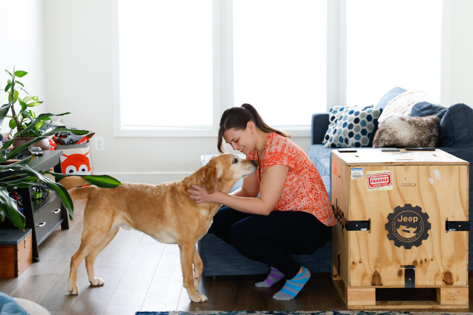 Nikki Cheshire pets her dog Bishop in the living room of her Frederick County townhouse. (Julia Nikhinson for The Washington Post)