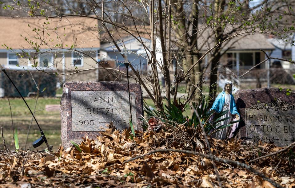 Tombstones covered in fallen leaves sit inside the Oak Grove Burying Ground in Taylor on Wednesday, April 12, 2023. 