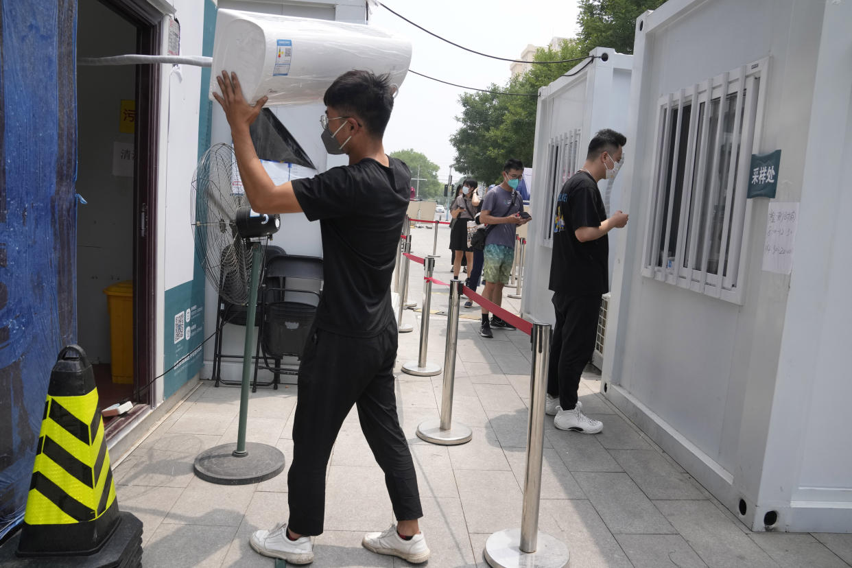 Air-conditioning units are installed as summer heats up at a Covid test site in Beijing in June. (Ng Han Guan / AP)