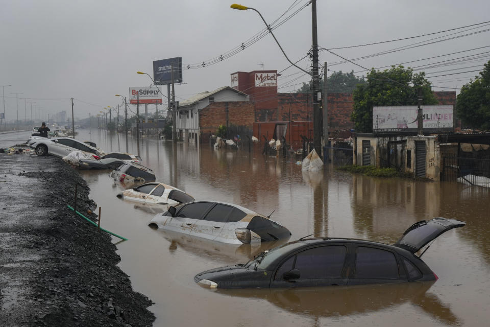 Vehicles are partially submerged on a street flooded by heavy rains in Sao Leopoldo, Rio Grande do Sul state, Brazil, Saturday, May 11, 2024. (AP Photo/Andre Penner)