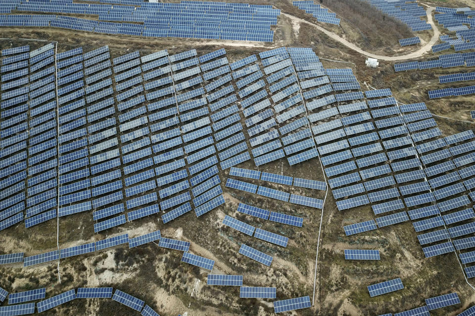 FILE - In this Nov. 27, 2019, file photo, a solar panel installation is seen in Ruicheng County in central China's Shanxi Province. China's Premier Li Keqiang announced that the country would target a reduction of 18% in carbon intensity over the course of the next five years as part of the meeting of the ceremonial legislature which kicked off its annual meeting Friday, March 5, 2021. (AP Photo/Sam McNeil, File)