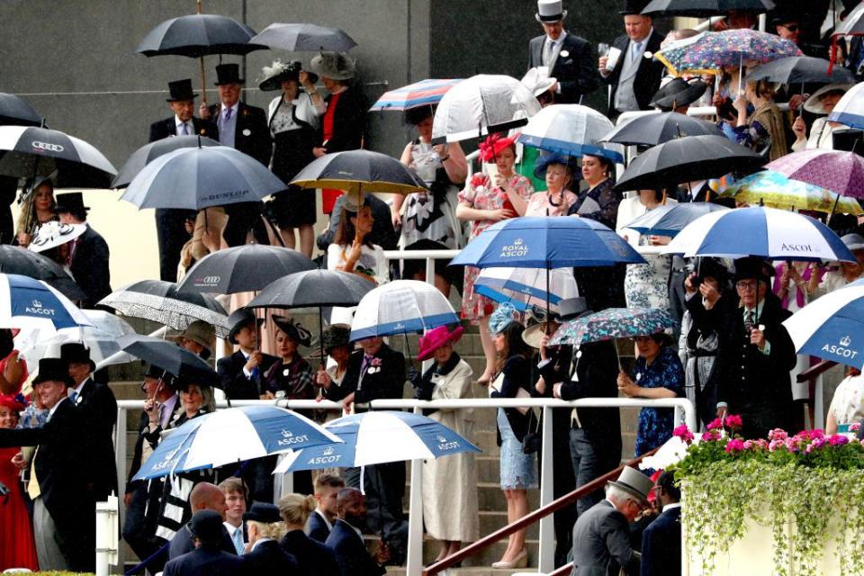 <p>Typical British weather had attendees sheltering from the rain during day one of Royal Ascot.</p>