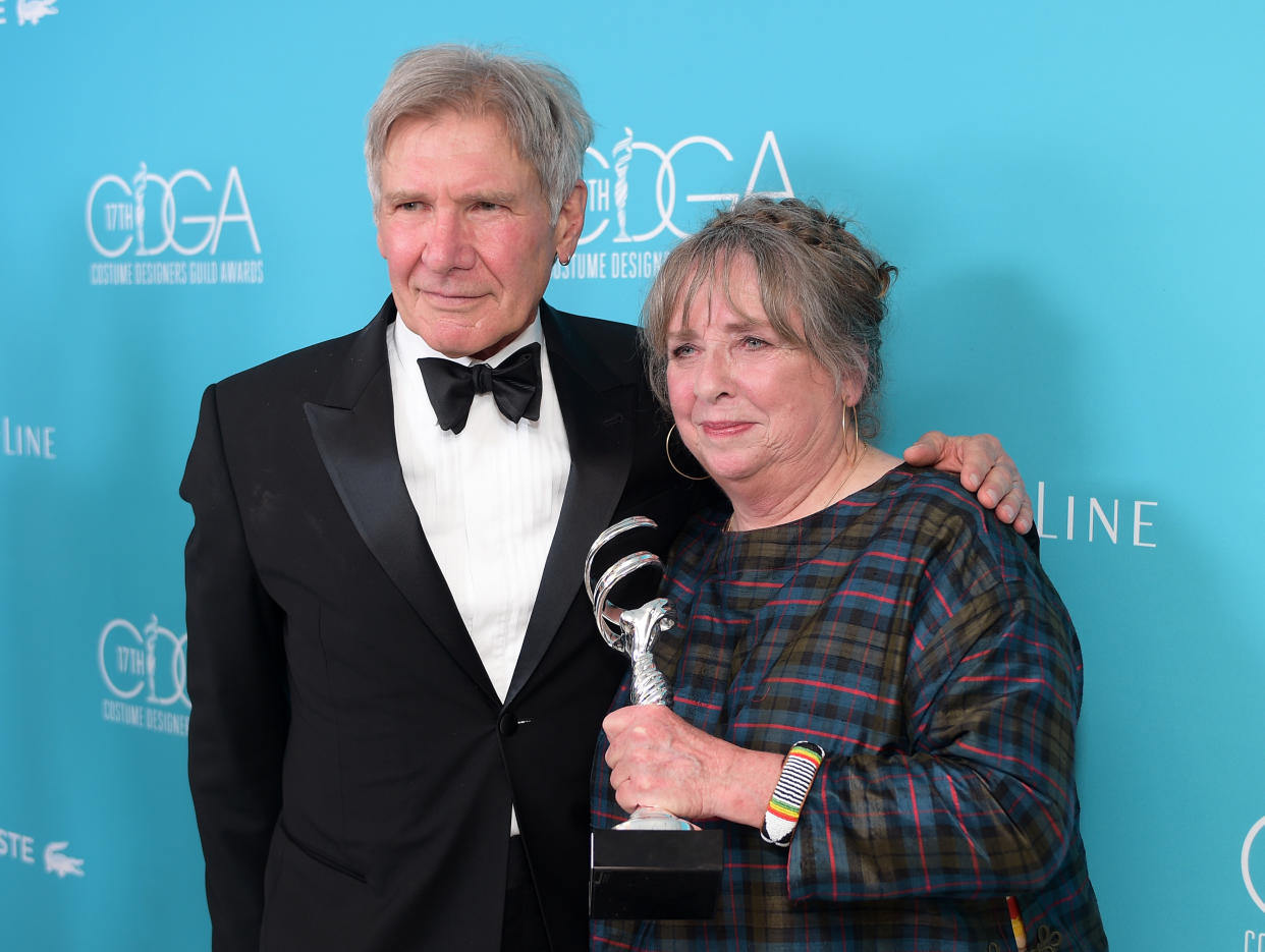 BEVERLY HILLS, CA - FEBRUARY 17:  Costume designer Aggie Guerard Rodgers recipient of the Career Achievement Award (R) with actor Harrison Ford backstage at the 17th Costume Designers Guild Awards with presenting sponsor Lacoste at The Beverly Hilton Hotel on February 17, 2015 in Beverly Hills, California.  (Photo by Stefanie Keenan/Getty Images for CDG)