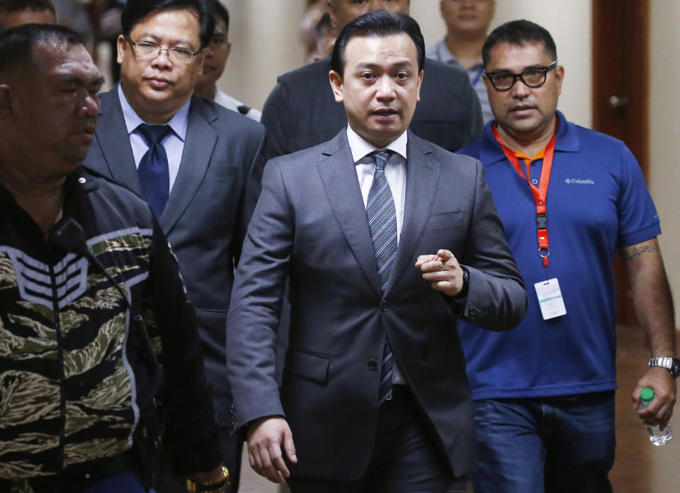Philippine opposition Sen. Antonio Trillanes IV arrives back to the Philippine Senate after posting bail before a regional trial court after an arrest warrant was issued Tuesday, Sept. 25, 2018 in suburban Pasay city, south of Manila, Philippines. Trillanes IV vowed to remain holed up in his office at the Senate until he is cleared of all the charges against him after President Rodrigo Duterte voided an amnesty given to the former rebel military officer. (AP Photo/Bullit Marquez)