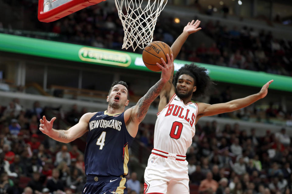 New Orleans Pelicans' JJ Redick (4) drives past Chicago Bulls' Coby White during the first half of an NBA preseason basketball game Wednesday, Oct. 9, 2019, in Chicago. (AP Photo/Charles Rex Arbogast)