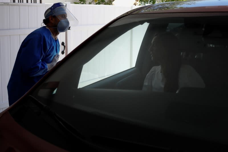 A plastic surgeon conducts drive-through Botox injections in the garage of his clinic in Miami