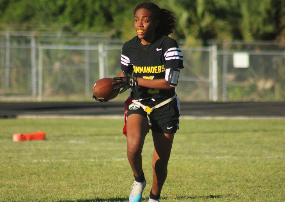 Ed White running back Tyra Pierce (5) rushes for yardage after taking a pitch against Fletcher in the Gateway Conference girls flag football championship.