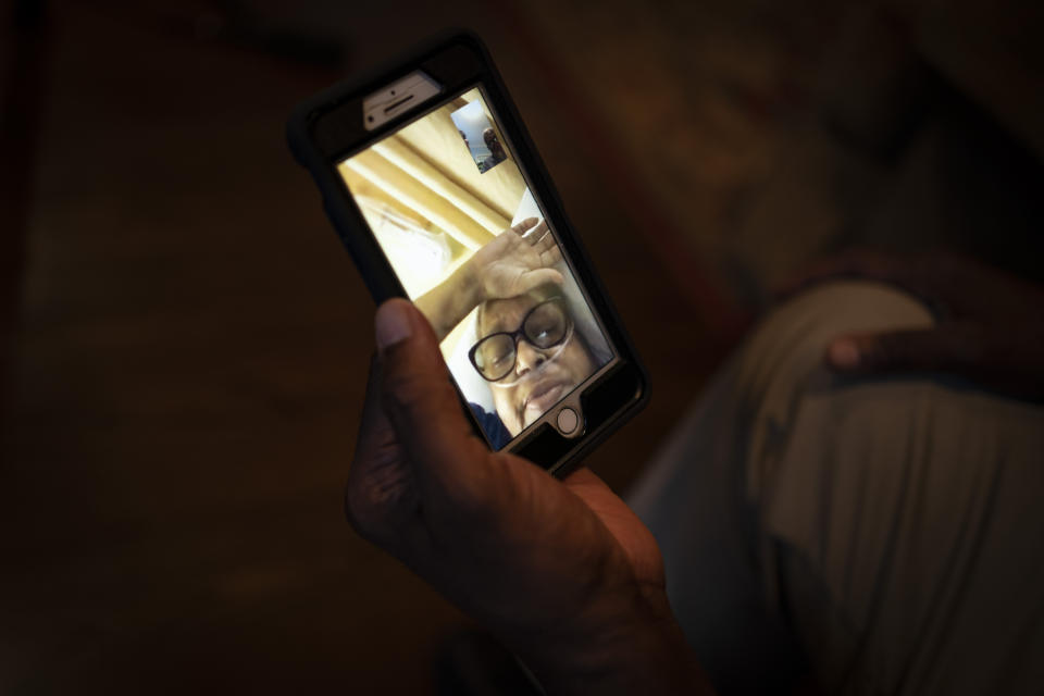 Mike Bishop video chats in Byram, Miss., with his wife, Bonnie Bishop, who is hospitalized 40 miles away, on Thursday, Oct. 8, 2020. He's hoping she'll be back by Thanksgiving. (AP Photo/Wong Maye-E)