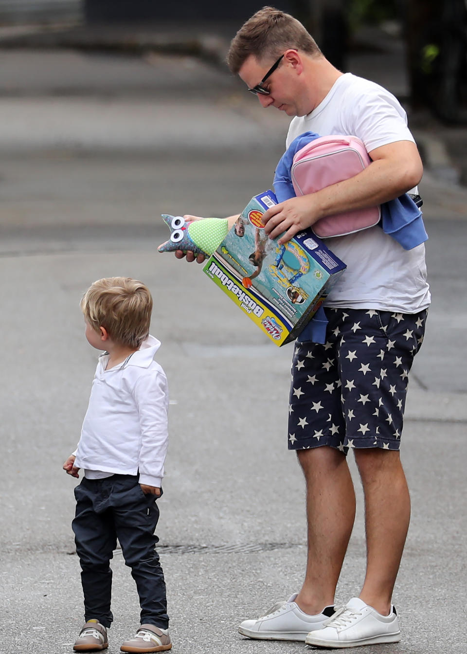 Ben held onto his children’s backpacks and snacks. Photo: Diimex