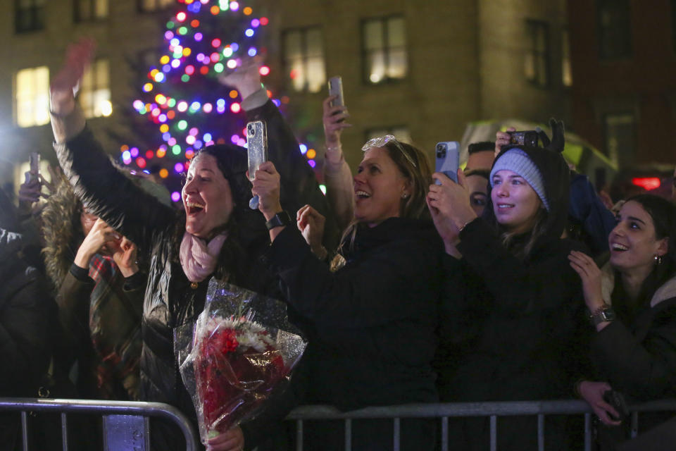 People react to Britain's Prince William and Kate, Princess of Wales, arrival at City Hall Plaza on Wednesday, Nov. 30, 2022, in Boston. The Prince and Princess of Wales are making their first overseas trip since the death of Queen Elizabeth II in September. (AP Photo/Reba Saldanha)