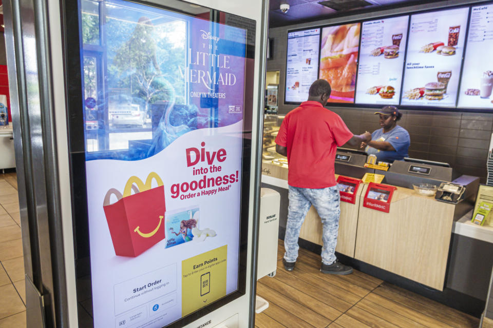 Glennville, Georgia, McDonald's fast food restaurant customer at cashier check out. (Photo by: Jeffrey Greenberg/Universal Images Group via Getty Images)