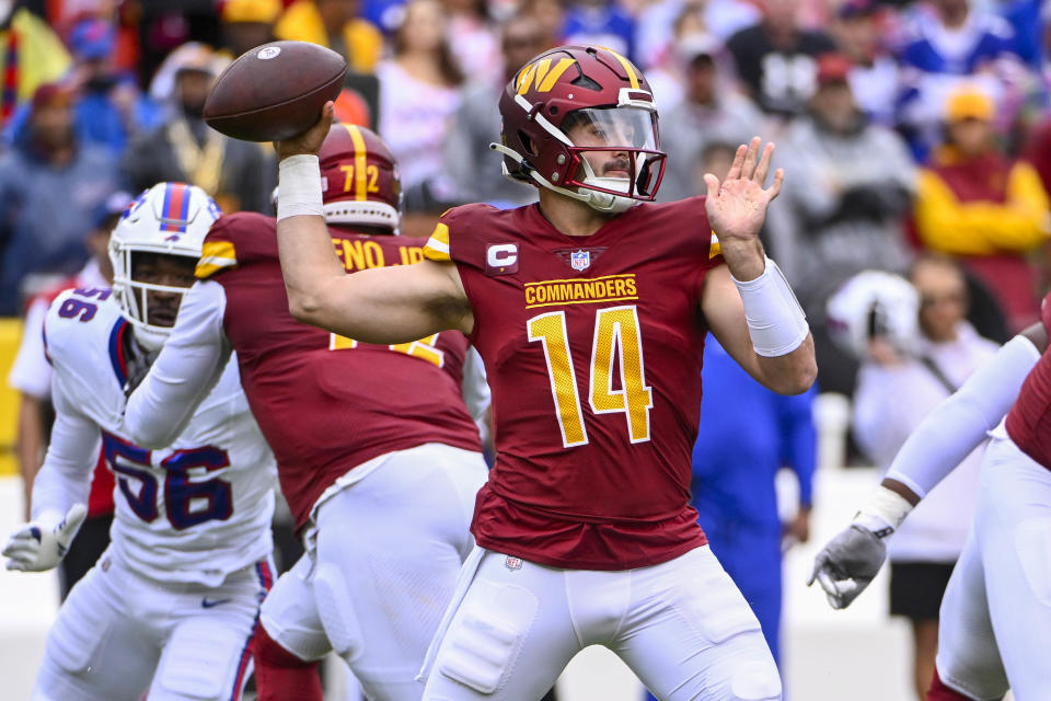 Sep 24, 2023; Landover, Maryland, USA; Washington Commanders quarterback Sam Howell (14)j attempts a pass against the Buffalo Bills during the first half at FedExField. Mandatory Credit: Brad Mills-USA TODAY Sports
