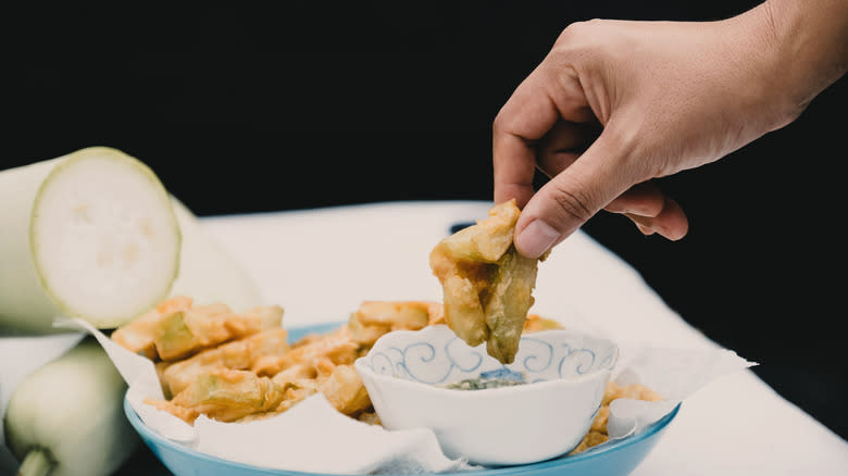 Hand dipping Calabash-style seafood