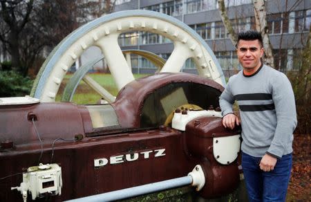 Qudratullah Hotak, a 25-year-old refugee from Afghanistan and one of 24 trainees of Ford Motor Co's so-called EQ qualification program to integrate migrants in a booming labour market, leans on a historic engine in front of his vocational training college in Cologne, Germany, January 11, 2019. Picture taken January 11, 2019. REUTERS/Wolfgang Rattay