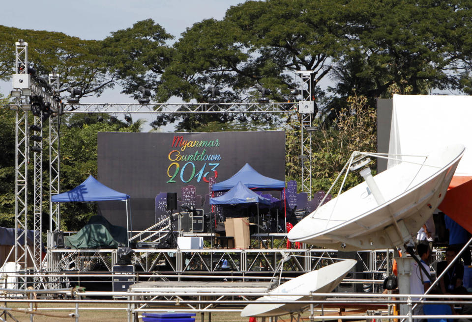 Workers take a rest as they prepare to set up a stage as preparations are underway for the country's first ever public New Year's countdown celebration, at Myoma grounds in Yangon, Myanmar, Monday, Dec. 31, 2012. (AP Photo/Khin Maung Win)