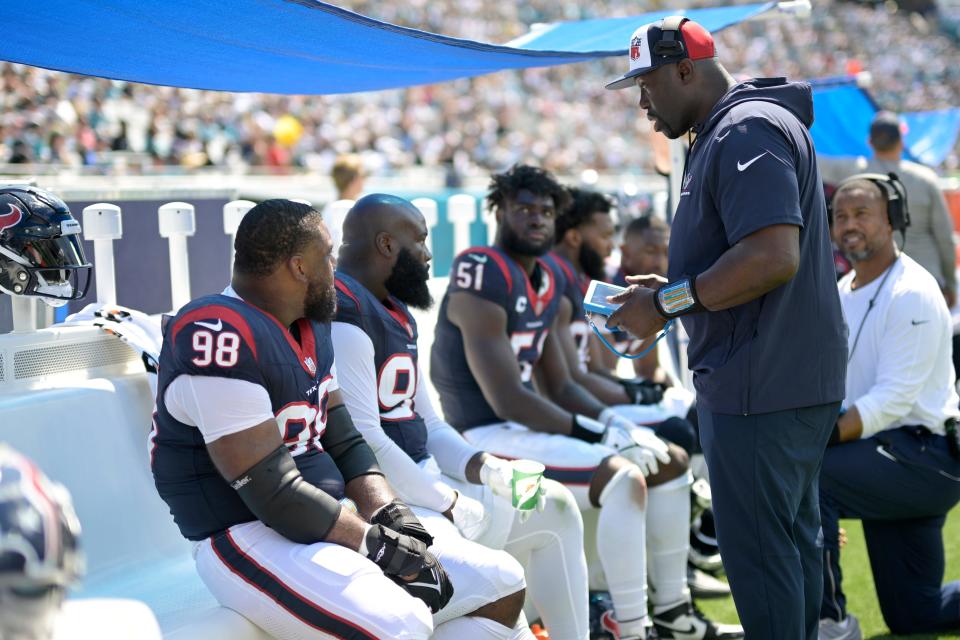Houston Texans defensive line coach Jacques Cesaire and assistant defensive line coach Rod Wright, right, talk with players on the sideline against the Jacksonville Jaguars on Sept. 24, 2023, in Jacksonville, Fla.