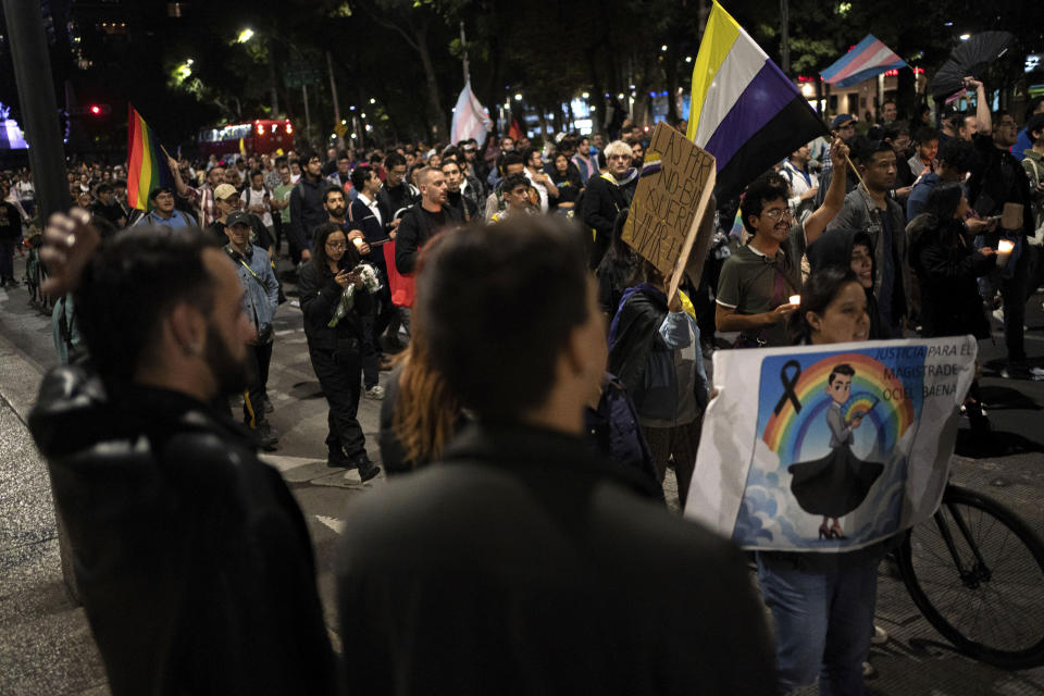 News anchor Guillermo Barraza, foreground, and his partner Francisco, join in a protest demanding justice over the death of Ociel Baena, the first openly nonbinary person in Latin America to hold a judicial position, in Mexico City, Monday, Nov. 13, 2023. “In this country, no one is safe,” Barraza said. “The more visible you are, the more you want to fight for change, the more you put a target on your own chest. And if we have to put our lives on the line, that’s what we’ll do, because we won’t let fear win.” (AP Photo/Aurea Del Rosario)