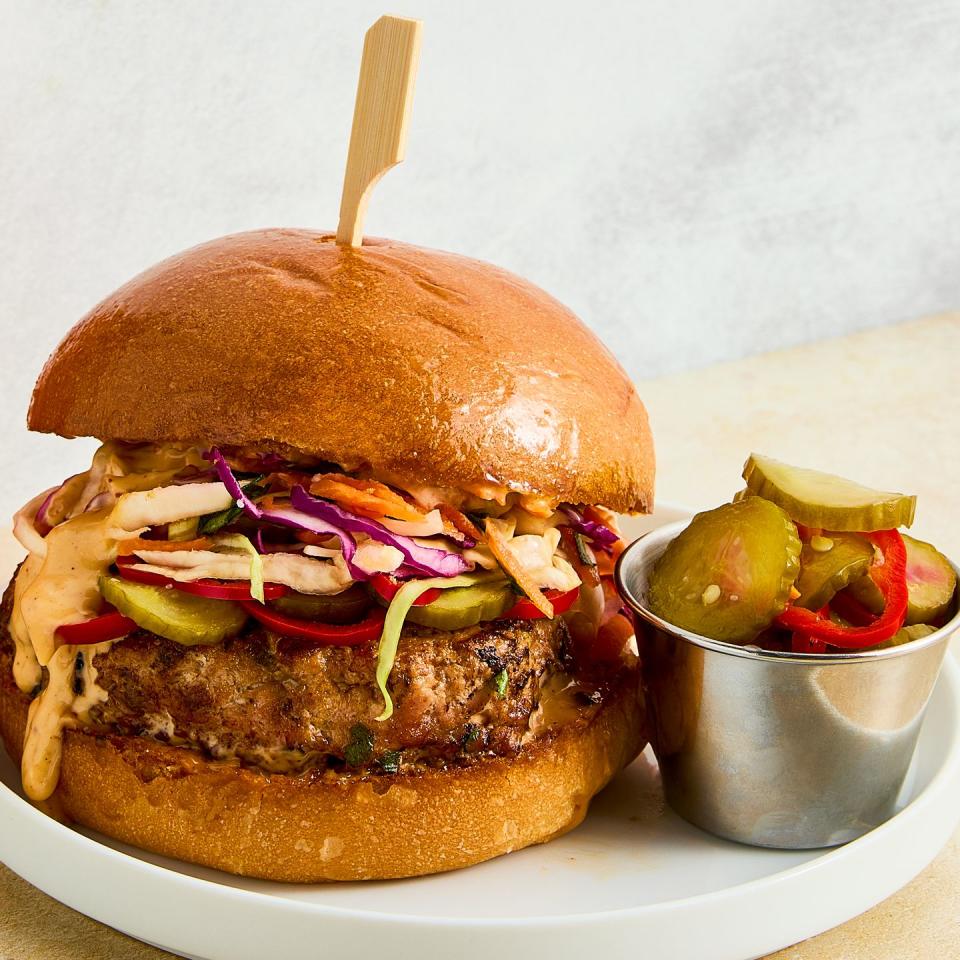 a ginger, garlic, and scallion studded turkey patty, pickled spicy peppers and cucumbers, a bright, crisp cabbage slaw, and plenty of sweet chili mayo all on a shiny, fluffy brioche bun