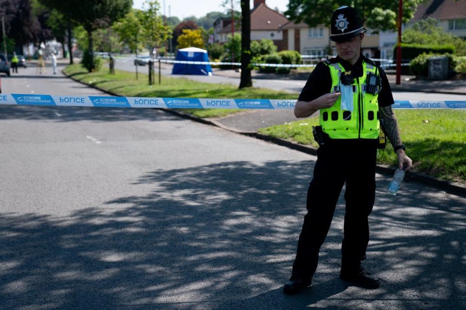 A police officer near the scene on College Road, a day after Dea-John’s death (Jacob King/PA) (PA Wire)