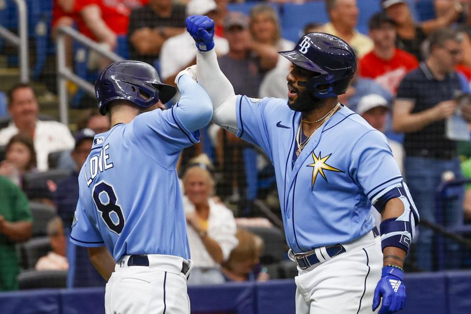 Tampa Bay Rays' Brandon Lowe (8) and Yandy Diaz (2) celebrate a solo home run in the first inning of a baseball game against the Boston Red Sox at Tropicana Field in St. Petersburg, Fla., Thursday, April 13, 2023. (Ivy Ceballo/Tampa Bay Times via AP)