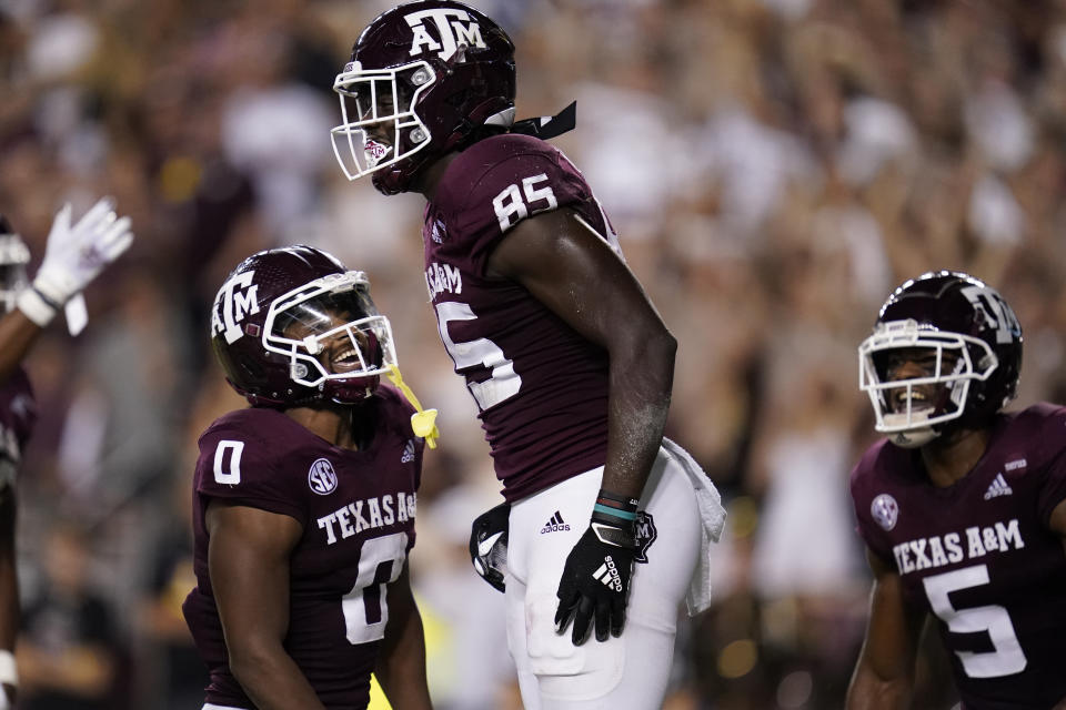 Texas A&M tight end Jalen Wydermyer (85) smiles with teammates Ainias Smith (0) and Jalen Preston (5) after scoring a 25-yard touchdown against South Carolina during the first quarter of an NCAA college football game on Saturday, Oct. 23, 2021, in College Station, Texas. (AP Photo/Sam Craft)