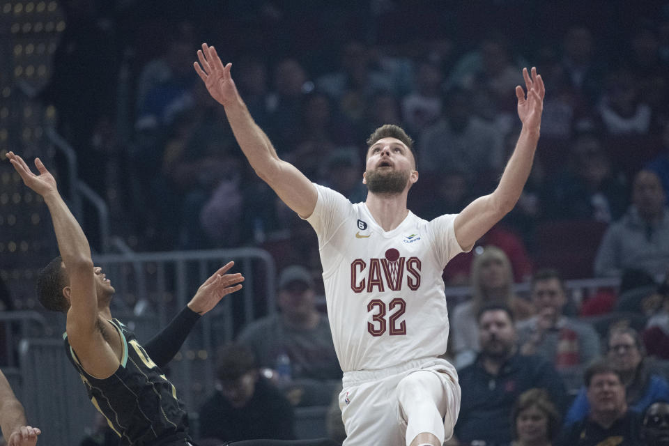 Cleveland Cavaliers' Dean Wade (32) watches the ball after defending Charlotte Hornets' Bryce McGowens (7) during the first first half of an NBA basketball game in Cleveland, Sunday, April 9, 2023. (AP Photo/Phil Long)