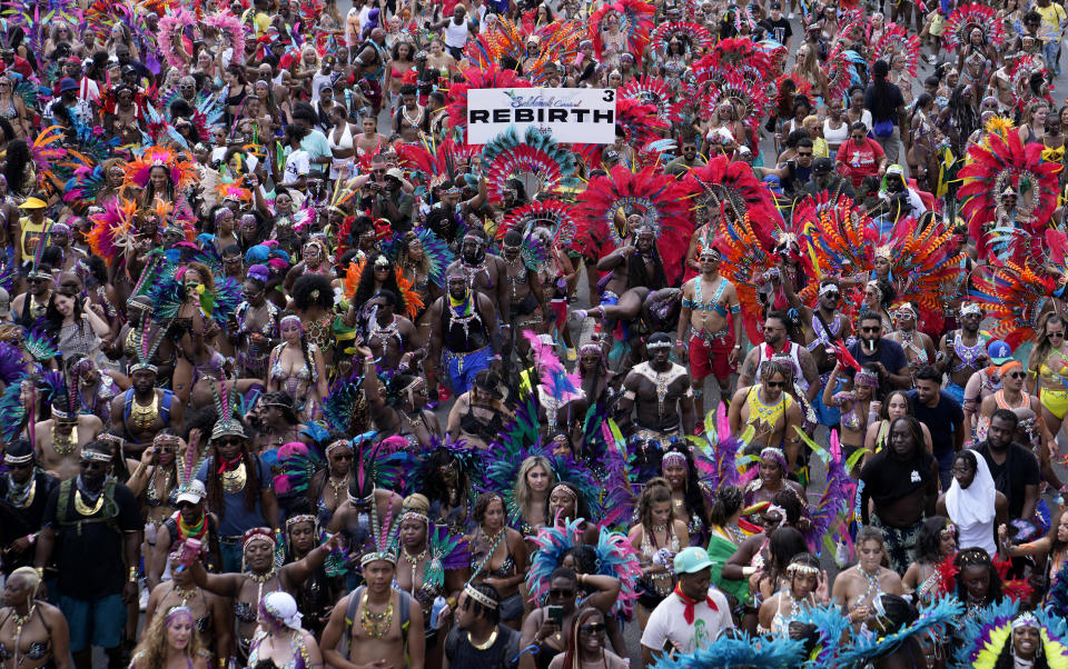 Masqueraders attend the Caribbean Carnival parade in Toronto, Canada, Saturday, July 30, 2022. The 55th annual parade returned to the streets after the COVID-19 pandemic cancelled it for two years in a row. (AP Photo/Kamran Jebreili)