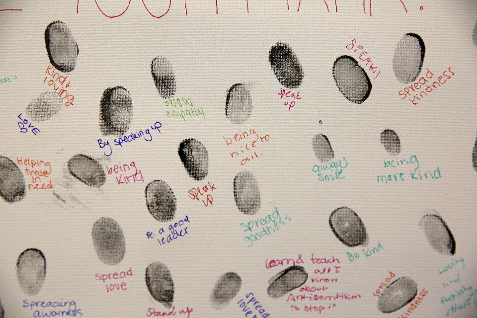 Participants in the Hate Ends Now Cattle Car program left their finger print with a message of how they will leave their mark following a discussion about their experience.