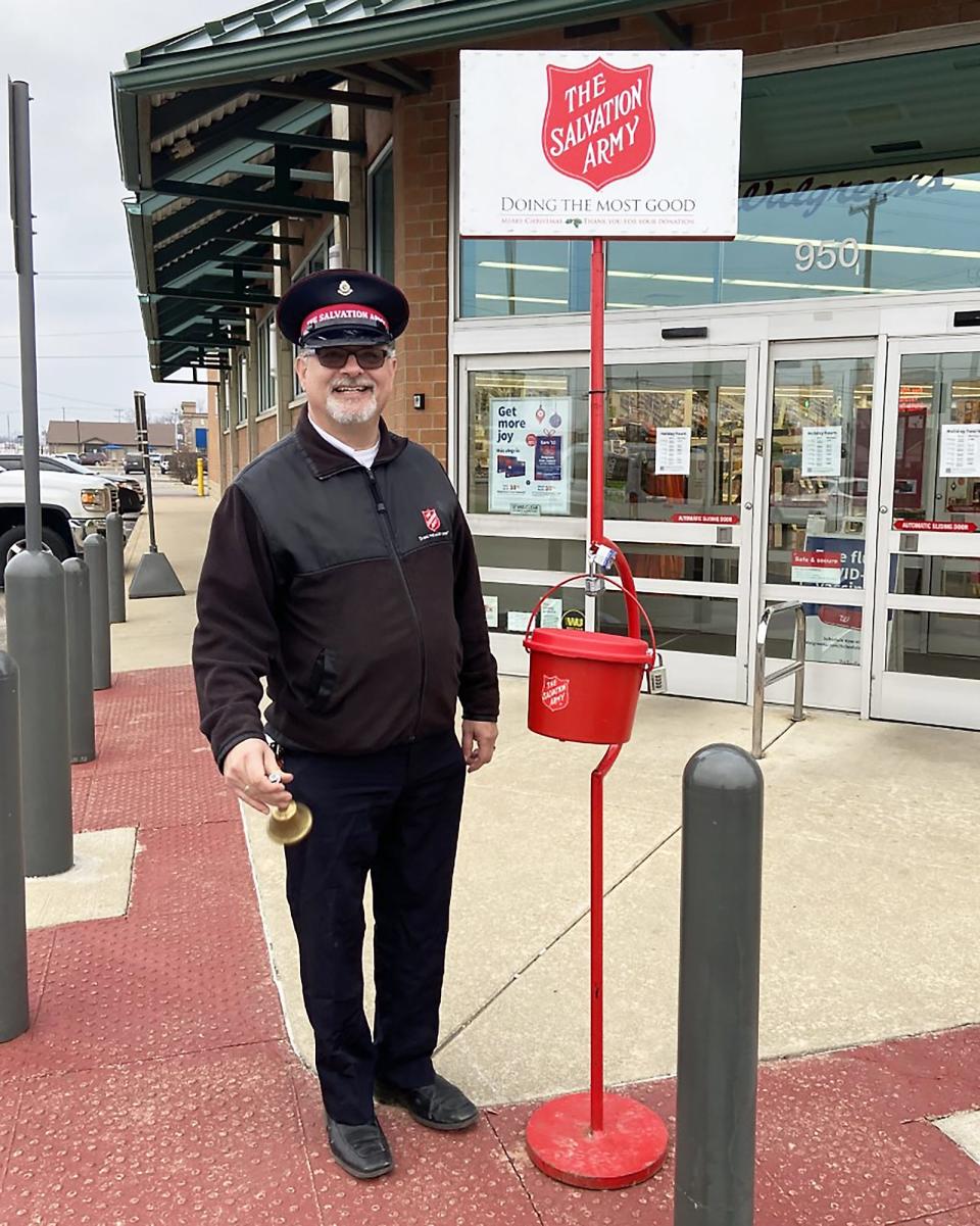 Major Tim Sell rings bells for The Salvation Army outside a shop in Sturgis.