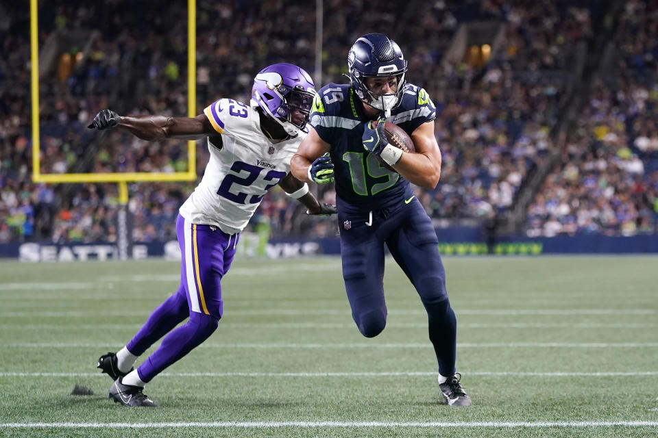 Seattle Seahawks wide receiver Jake Bobo (19) runs for a touchdown against Minnesota Vikings cornerback Andrew Booth Jr. (23) during the second half of an NFL preseason football game in Seattle, Thursday, Aug. 10, 2023. (AP Photo/Lindsey Wasson)