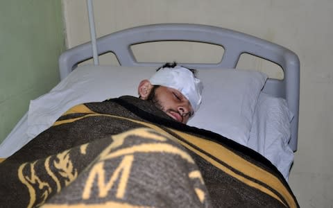 A Syrian pro-regime fighter wounded in the 7 February battle in Deir Ezzor - Credit: AFP Photo/Getty Images